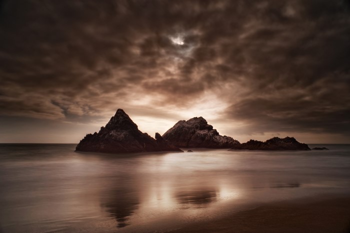 Rocky coast with thunderclouds over the sea
