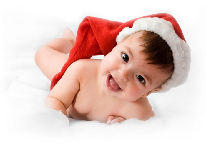 Baby wearing a Santa hat smiling