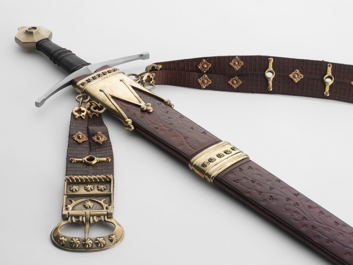 Sword with ornate leather scabbard and belt