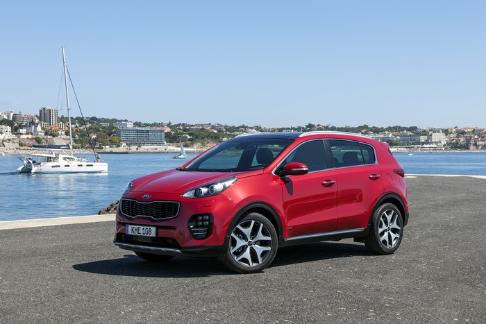 Red 2015 Kia Sportage by the Water
