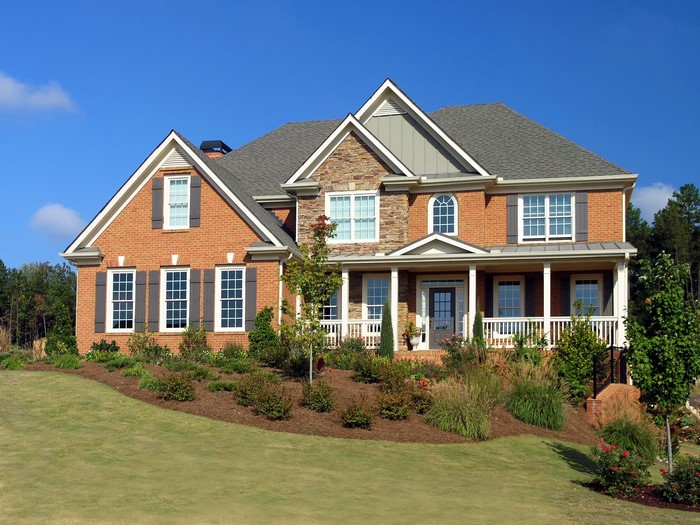 Brick house with stone accents and manicured lawn
