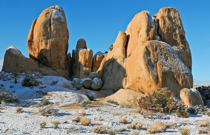 Snow-covered rock formations under a clear blue sky