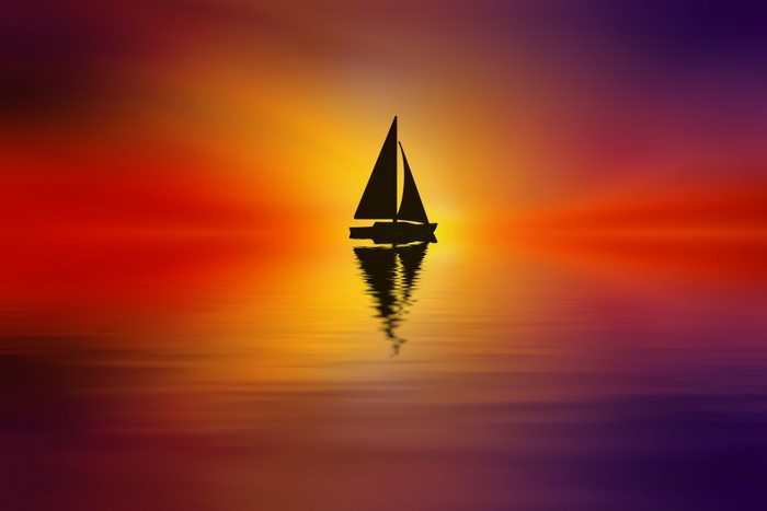 Sailboat silhouette on a colorful sunset over water