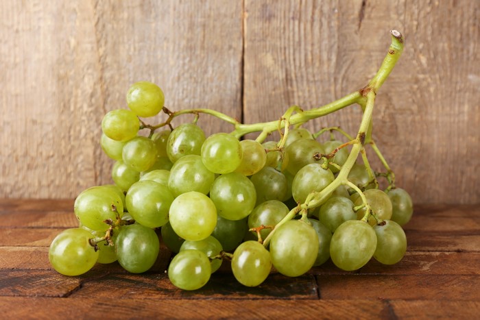 Green Grapes on Wooden Background