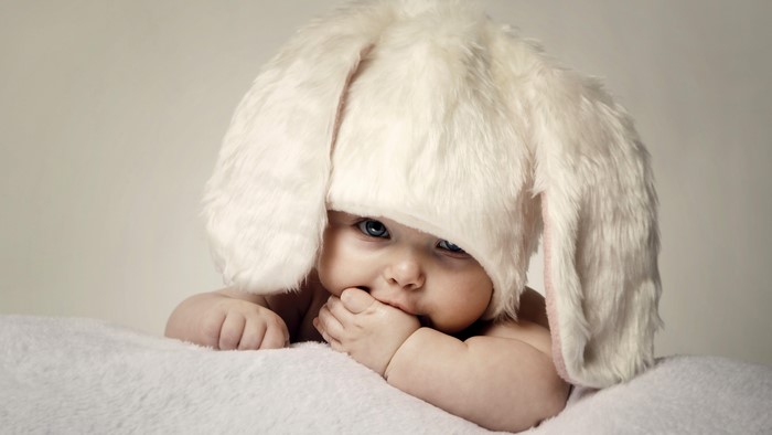 Baby wearing a fluffy white bunny hat