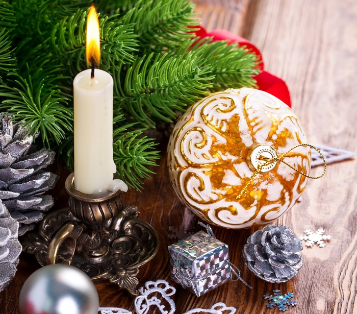Christmas candle and ornaments with pine branches