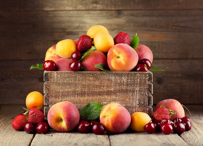 Fruit in a wooden box: Peaches, Cherries, Strawberries