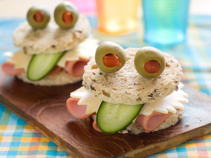 Frog-shaped sandwiches with olives, cheese, ham, and cucumber