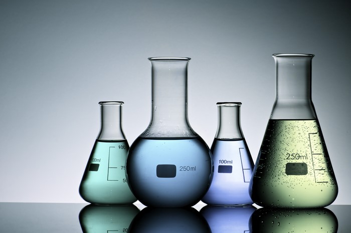 Four laboratory flasks with colored liquids