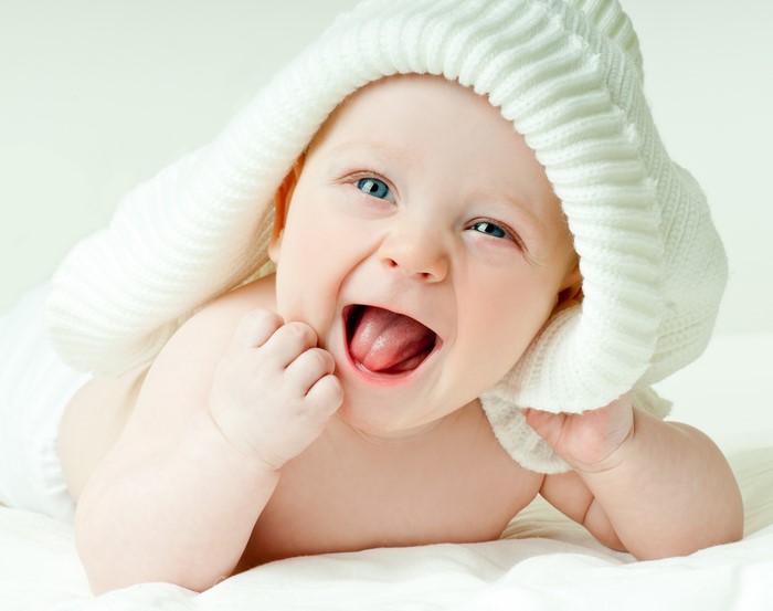 Baby wearing a white knitted hat