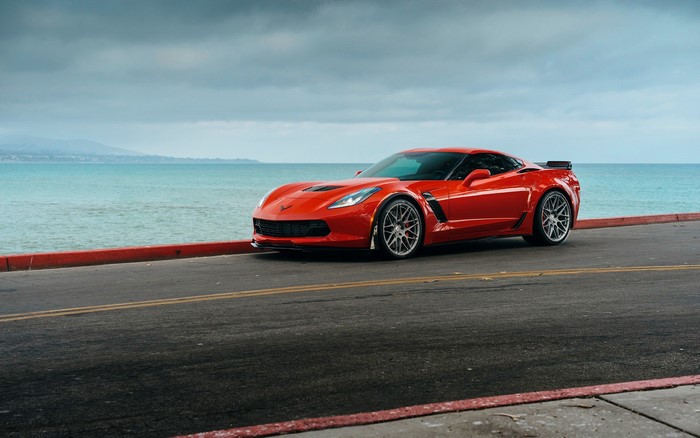 Red Chevrolet Corvette Z06 parked by the ocean