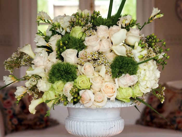 White and green floral arrangement in a vase