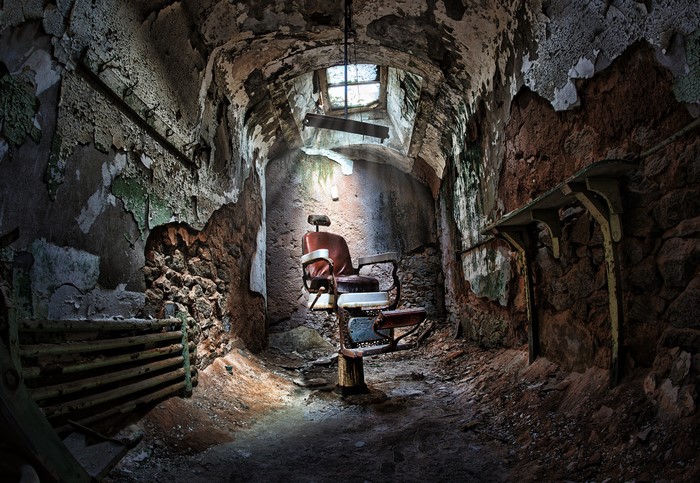 Abandoned barber chair in a derelict room