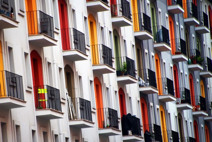 Colorful apartment building balconies with black railings