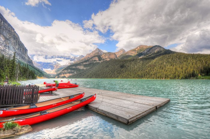 Red canoes on a wooden dock at Lake Louise, Canada