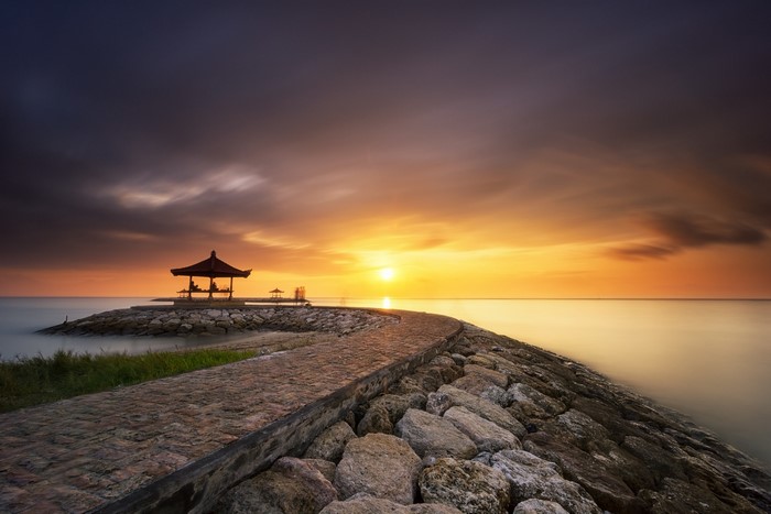 Gazebo on a stone pier at sunset