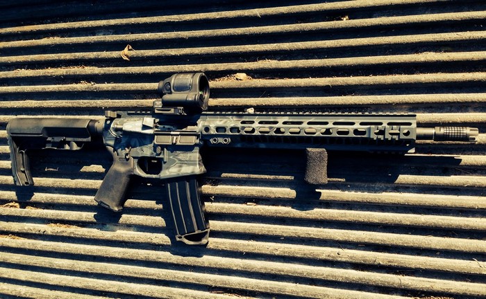 AR-15 style rifle with red dot sight