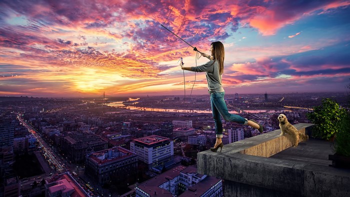 Woman with antenna and dog on rooftop at sunset