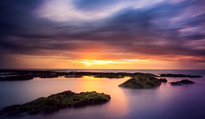 Sunset over the sea with rocks