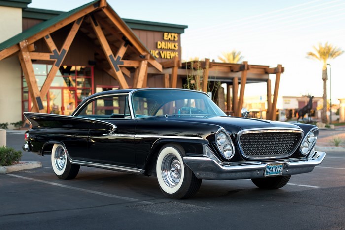 1961 Black Chrysler parked in front of a building