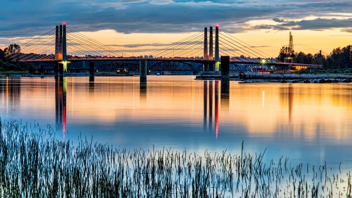 Cable-stayed bridge over river at sunset in Port Coquitlam, Canada