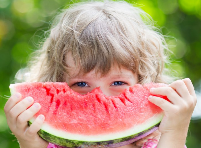 Little girl eating watermelon