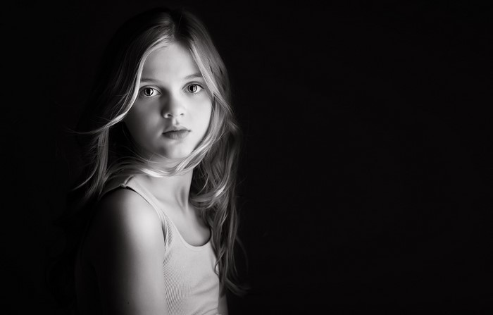 Young girl in singlet looking to the side