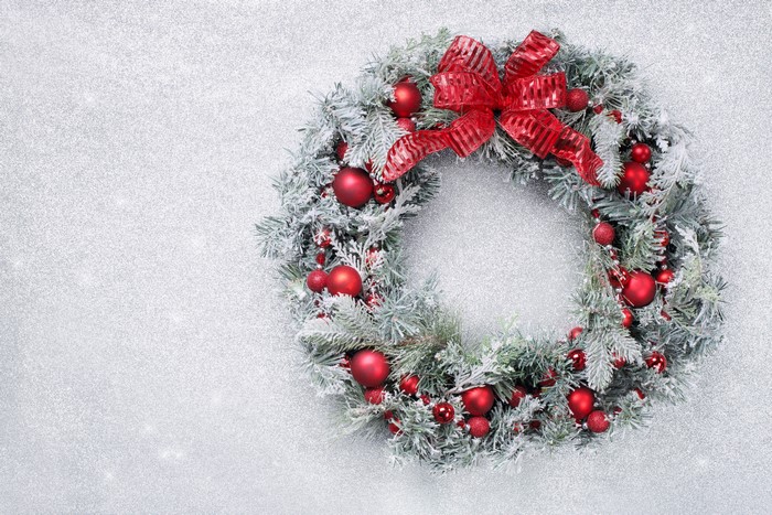 Christmas wreath with red ornaments and bow