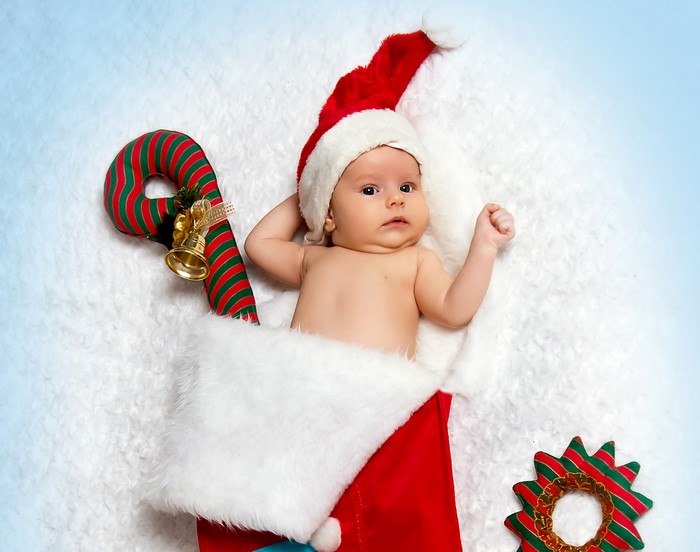 Baby in Santa hat in Christmas stocking