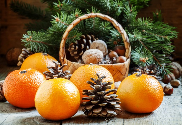 Christmas still life with tangerines, pine cones, nuts, and fir branches