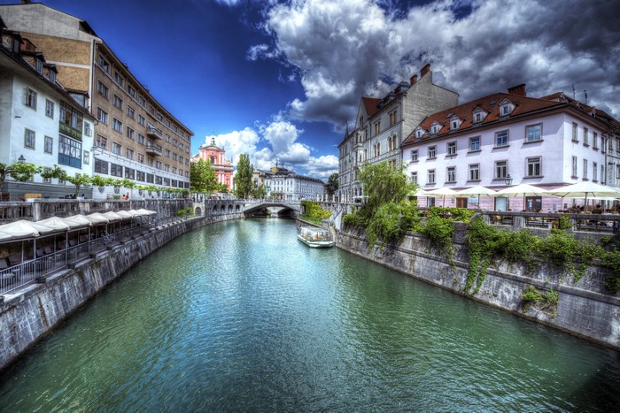 Ljubljana canal with buildings and a boat