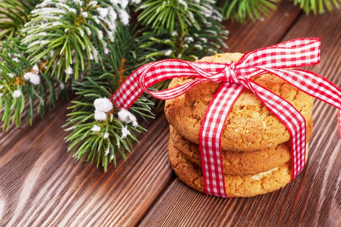Christmas cookies with red ribbon and pine branches