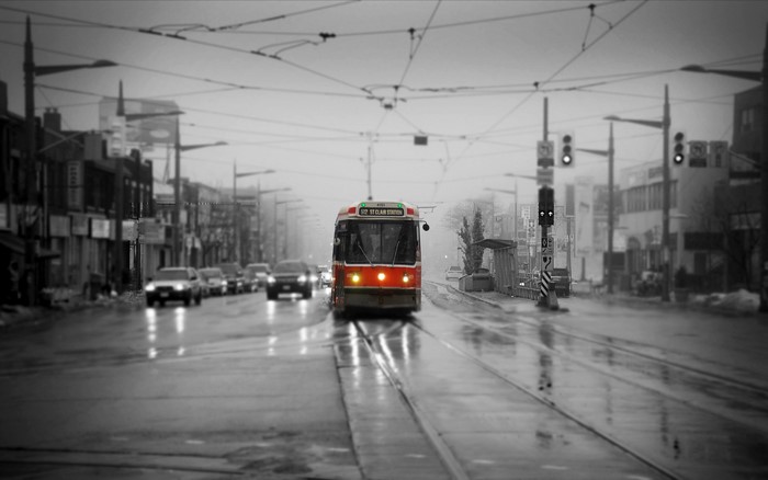Red streetcar on a wet street in Toronto