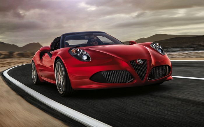 Red Alfa Romeo 4C Cabriolet driving on a road