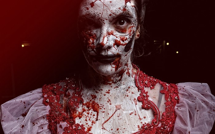 Woman with zombie makeup and blood splatters
