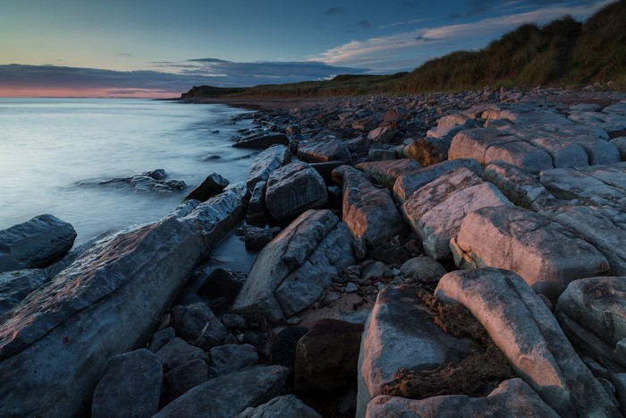 Rocky Coastline at Dusk with Gentle Waves