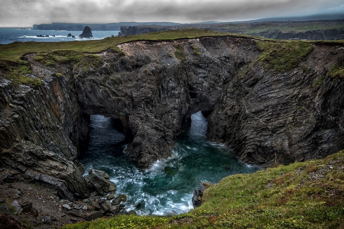Rocky coastline with sea arches and crashing waves