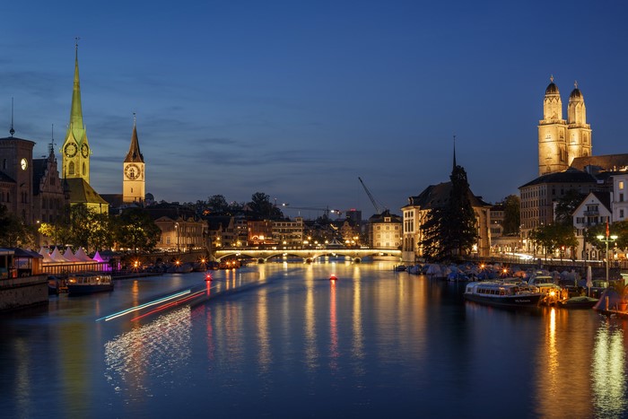 Zurich cityscape at night with river and bridges