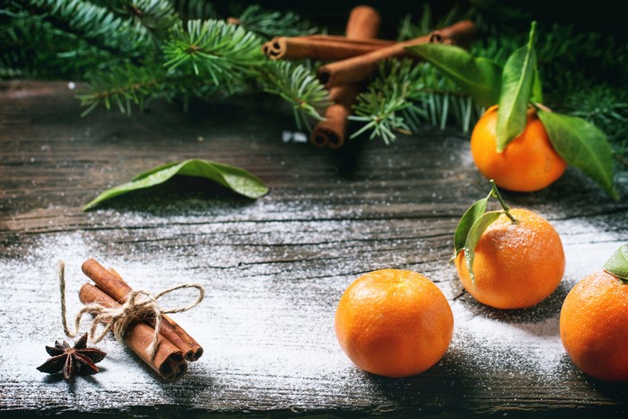 Tangerines and cinnamon sticks with pine branches