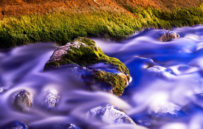 Mossy rocks in a flowing stream
