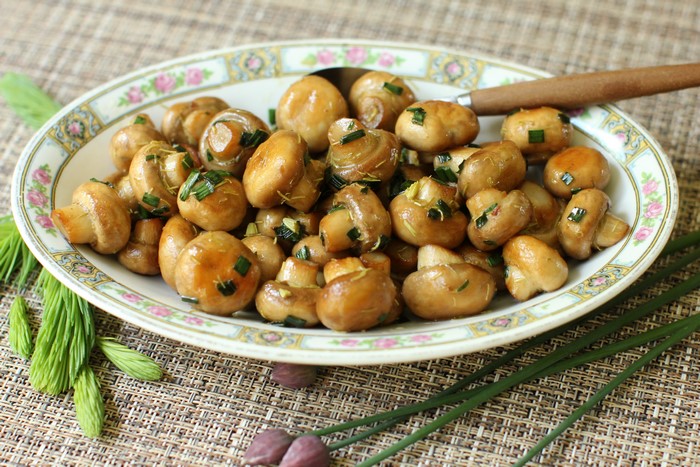 Champignon Mushrooms with Chives on a Plate