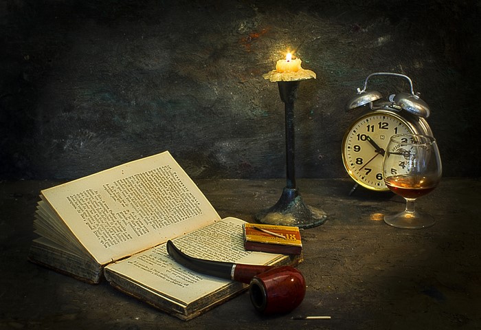 Still life with an open book, pipe, candle, and alarm clock