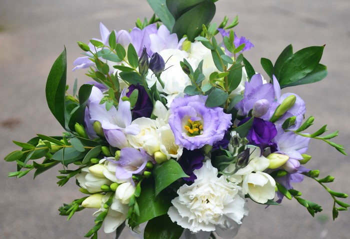 Purple and white flower bouquet with green leaves