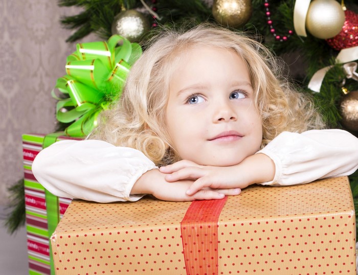 Little girl with Christmas gifts