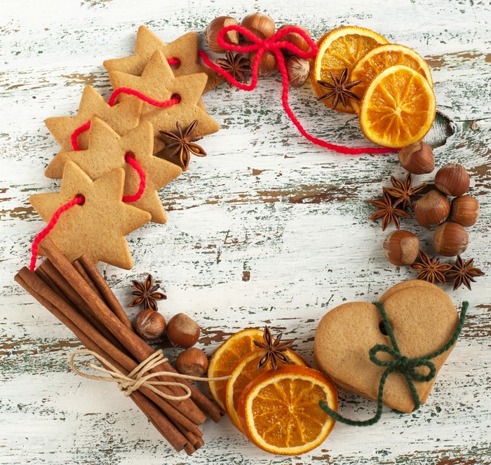 Christmas wreath with star cookies, oranges, nuts, and cinnamon