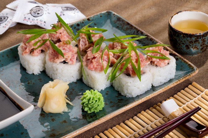 Sushi with tuna and green onions on a plate