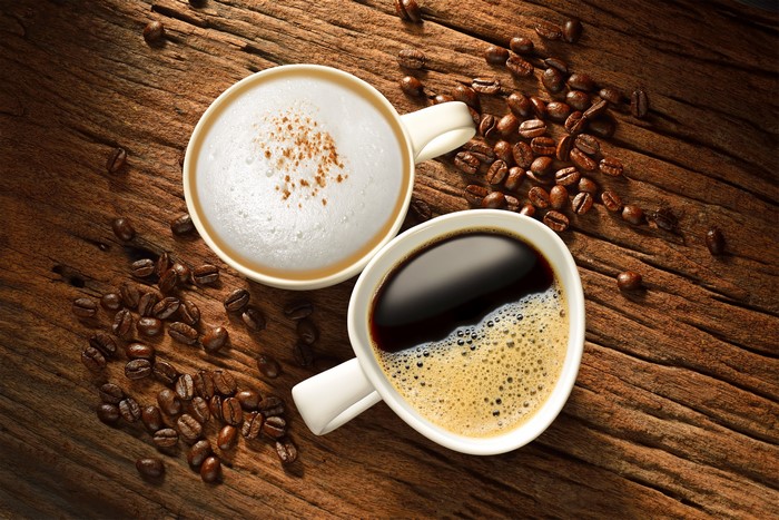 Two cups of coffee and coffee beans