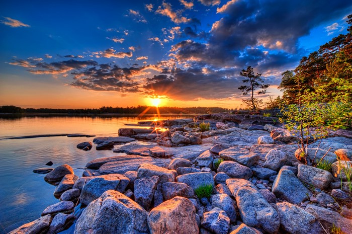 Sunset Over Rocky Lake Shore with Vibrant Sky
