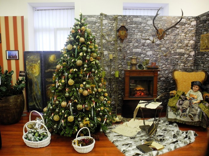 Christmas tree and boy by fireplace