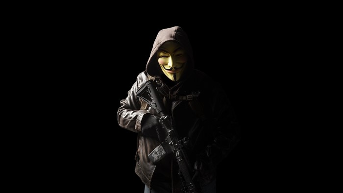 Man in Guy Fawkes mask holding a rifle